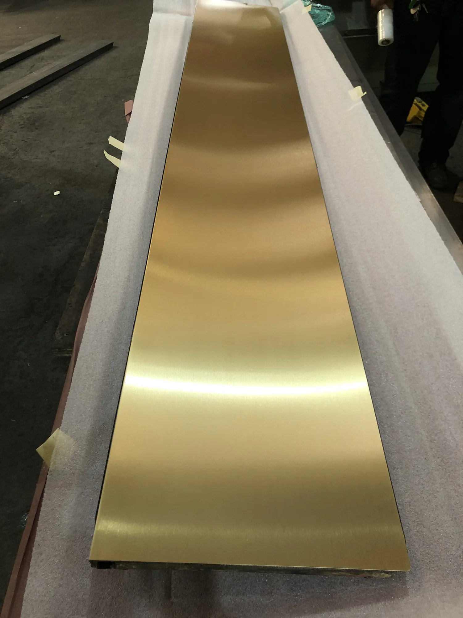 Close view of fabricated bronze elevator door panels with a directional satin finish